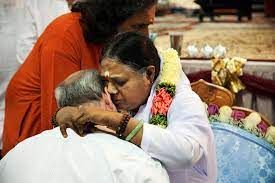 A woman hugging another person in front of another man.