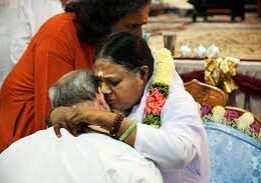 A woman hugging another person in front of another man.